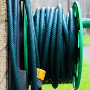 a garden hose reel on a wall